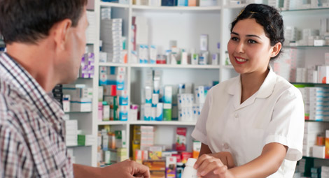female pharmacist giving a prescription to a customer
